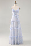 Vestido largo de invitada de boda con corsé floral azul con volantes en línea A