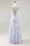 Vestido largo de invitada de boda con corsé floral azul con volantes en línea A