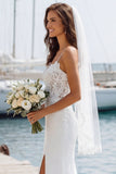 Vestido largo de novia con tirantes finos de marfil y abertura