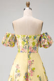 Vestido de invitad con alto y bajo con bordado floral amarillo y mangas abullonadas