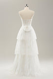 Vestido de novia largo con corsé sin tirantes blanco escalonado